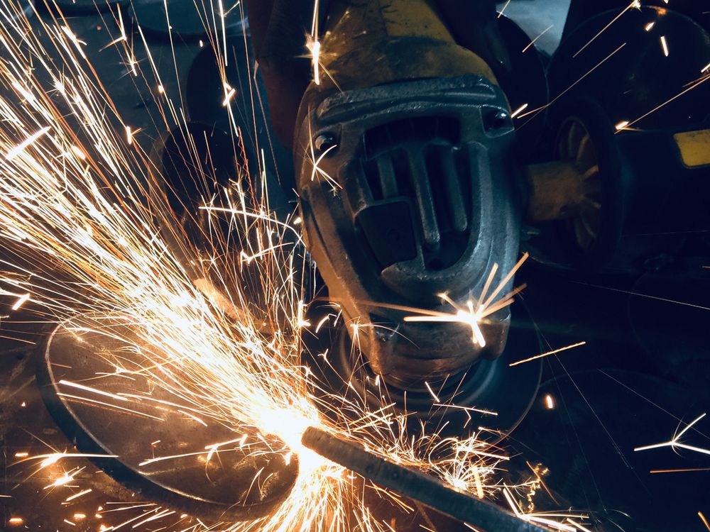 Grinding finished welds with sparks flying