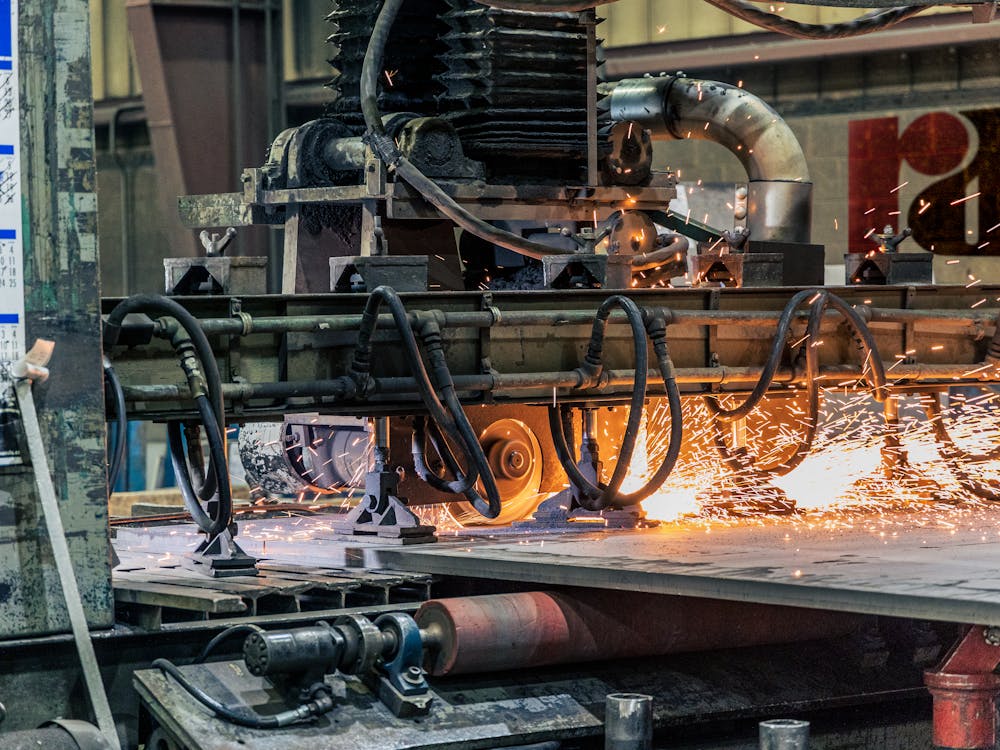 Industrial machinery cutting metal with sparks