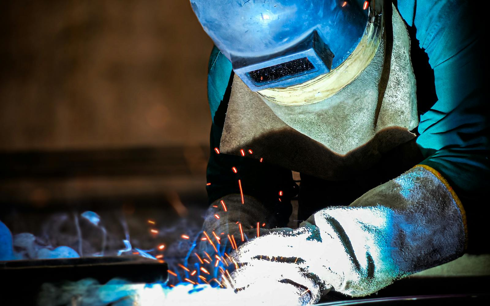 Close-up of welder with bright sparks